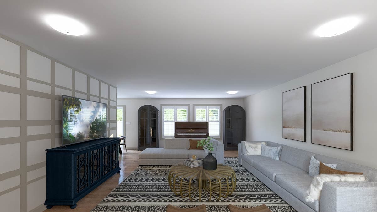 Living room with sectional sofa, piano, two arched cabinets, and decorative wall paneling.