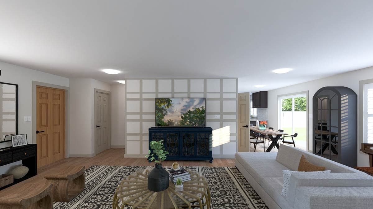 Open-concept living area with large sectional sofa, decorative wall paneling, a media console, and dining area with a table and chairs.