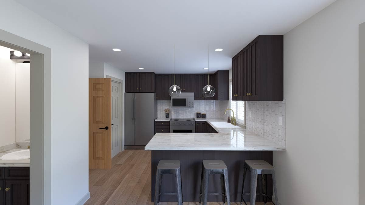 Kitchen with dark wood cabinets, marble island with pendant lights, stainless steel appliances, and subway tile backsplash.