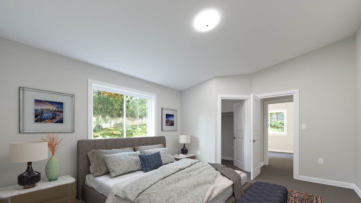 Primary bedroom with large window, bed, nightstand, and entry to closet and adjoining room.