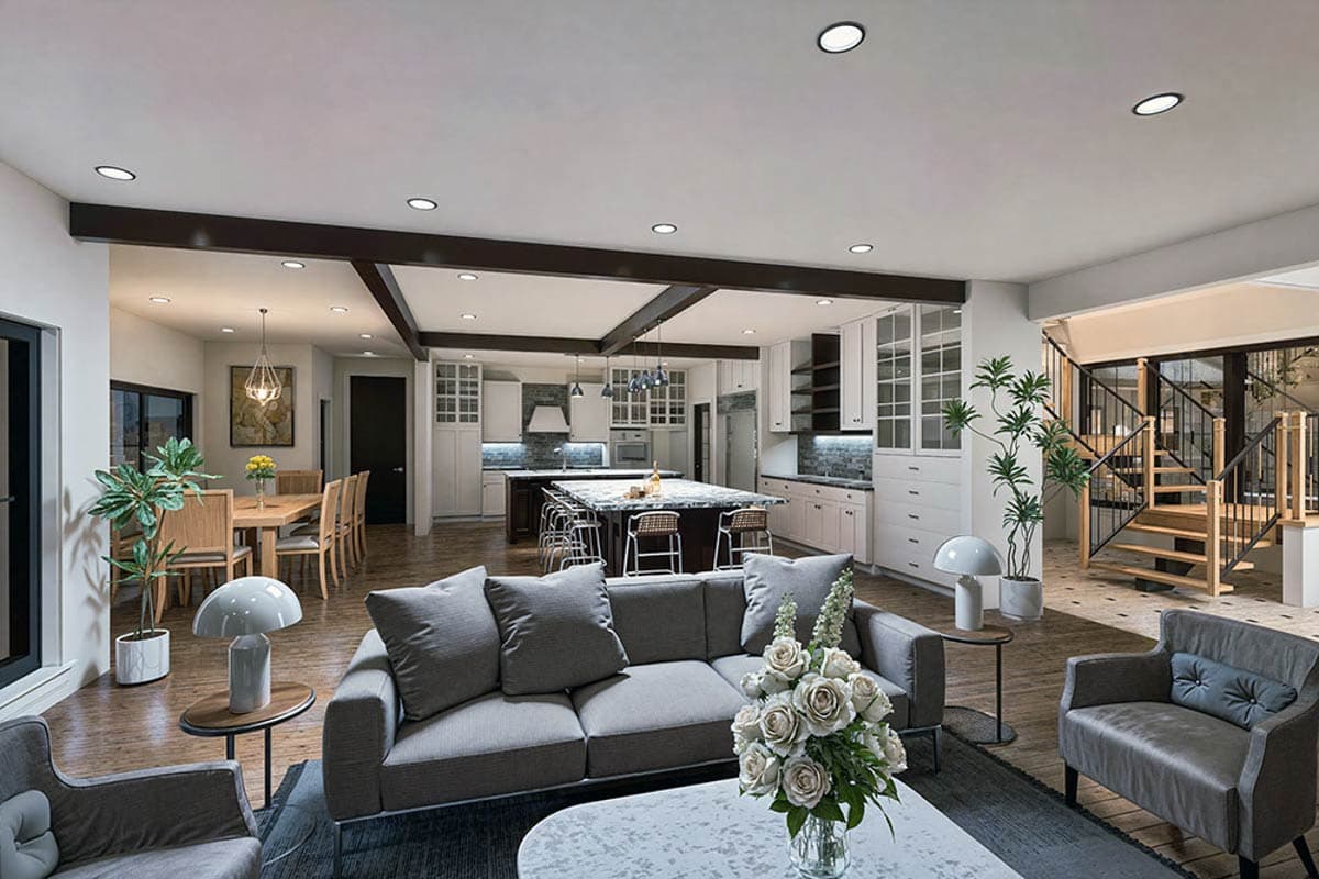 Open concept living, dining, and kitchen area with large island, coffered ceiling, and staircase.