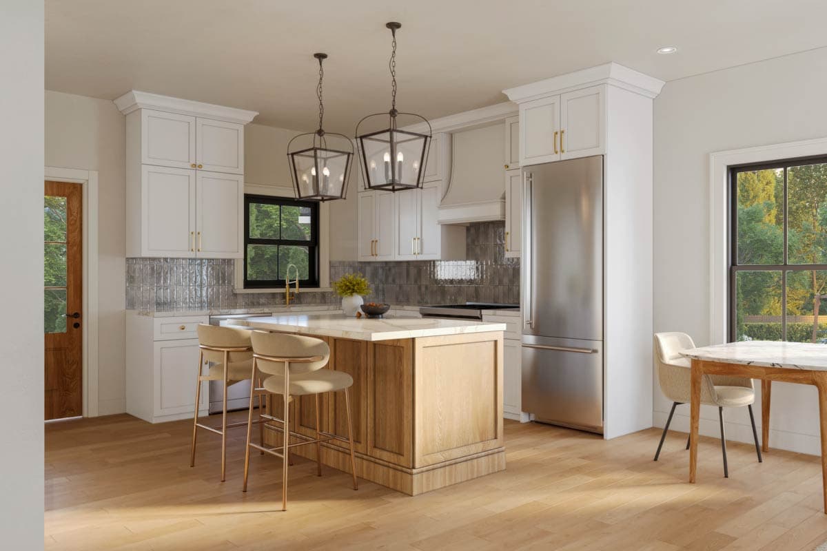 Kitchen with white cabinets, island with seating, stainless steel refrigerator, and pendant lights.