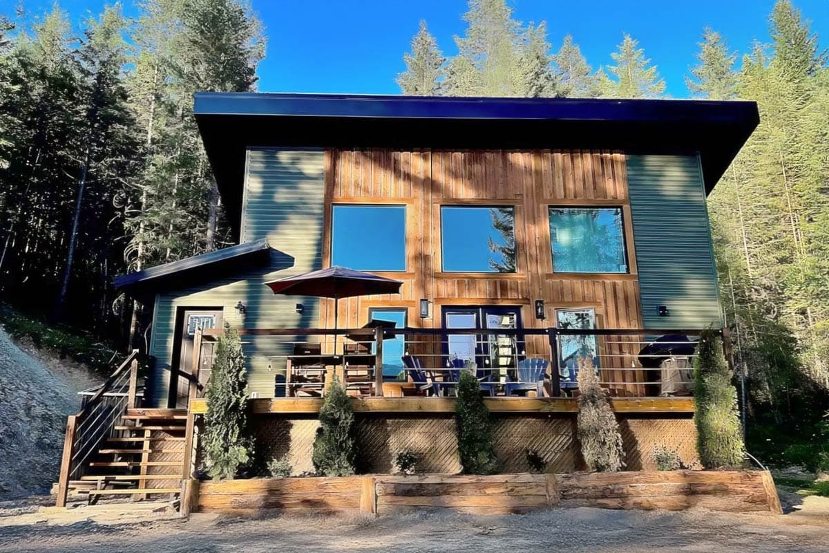 House plan exterior with two stories, a contemporary style, a deck, and a shed-style roof. Horizontal and vertical siding is used.