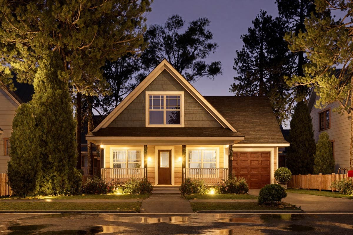House plan exterior: Craftsman style, two stories, prominent front gable, covered porch, and attached two-car garage.