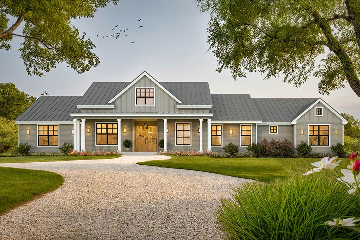 House plan exterior. Modern farmhouse style with gabled roof, prominent front porch with columns, and multiple dormers. Features a gravel driveway.