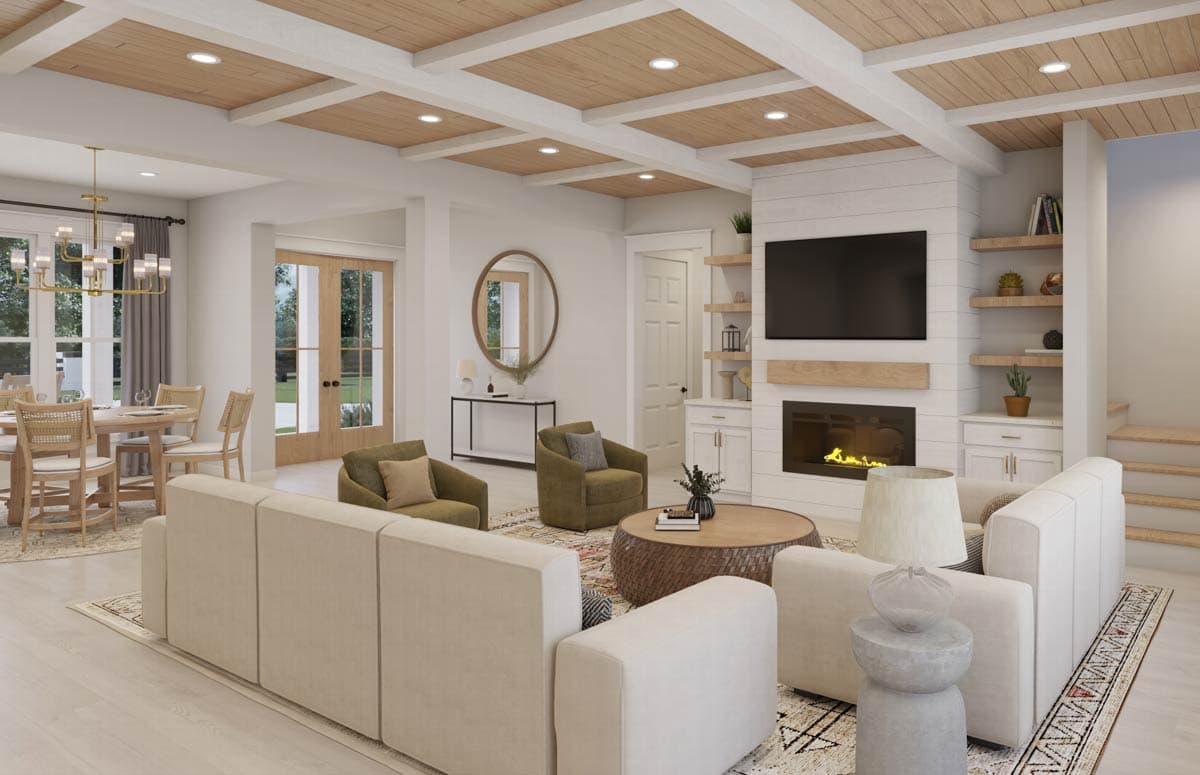 A modern living room with a fireplace, TV, and comfortable seating. Open to a dining area.