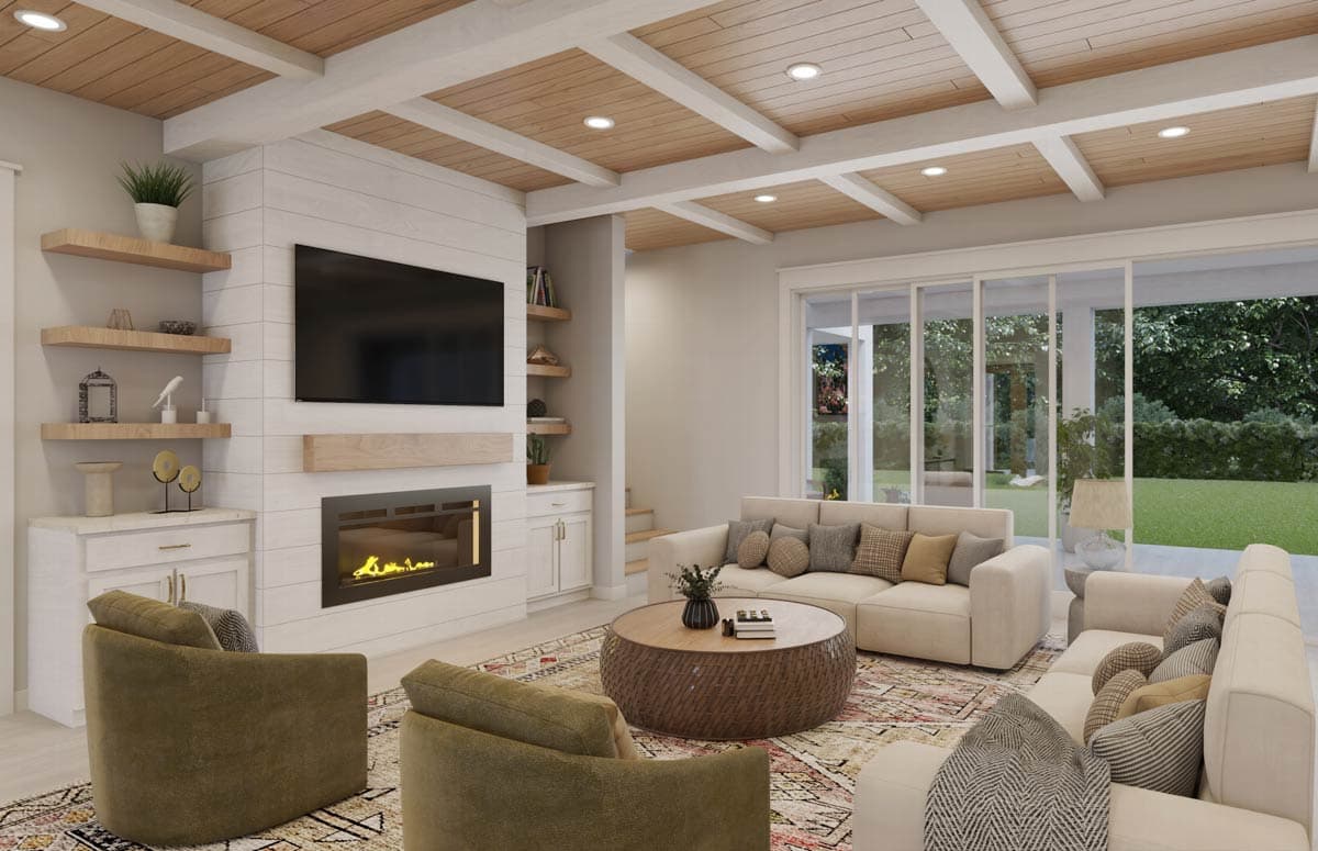 Modern living room with fireplace, TV, and sectional sofa. Features wood ceiling beams, sliding glass doors to a backyard.
