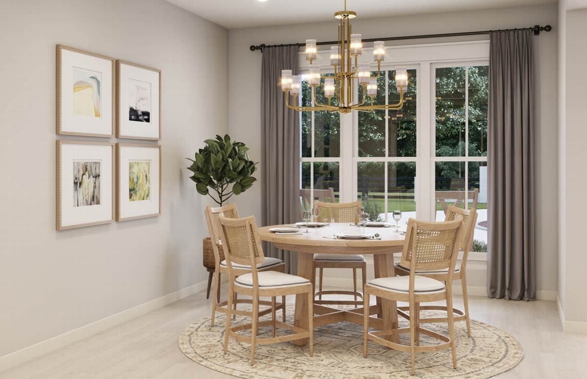 Elegant dining room with a round wooden table, chairs, artwork, chandelier, and large window with outdoor view.