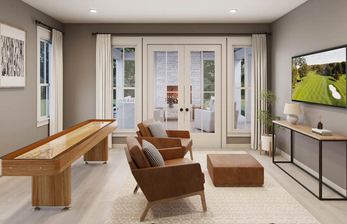 Modern living room with shuffleboard, leather chairs, and a TV showing a golf course.