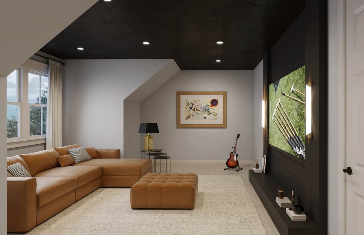 Modern living room with leather sectional, art, a large TV, and a black ceiling. The room is cozy with a guitar standing nearby.