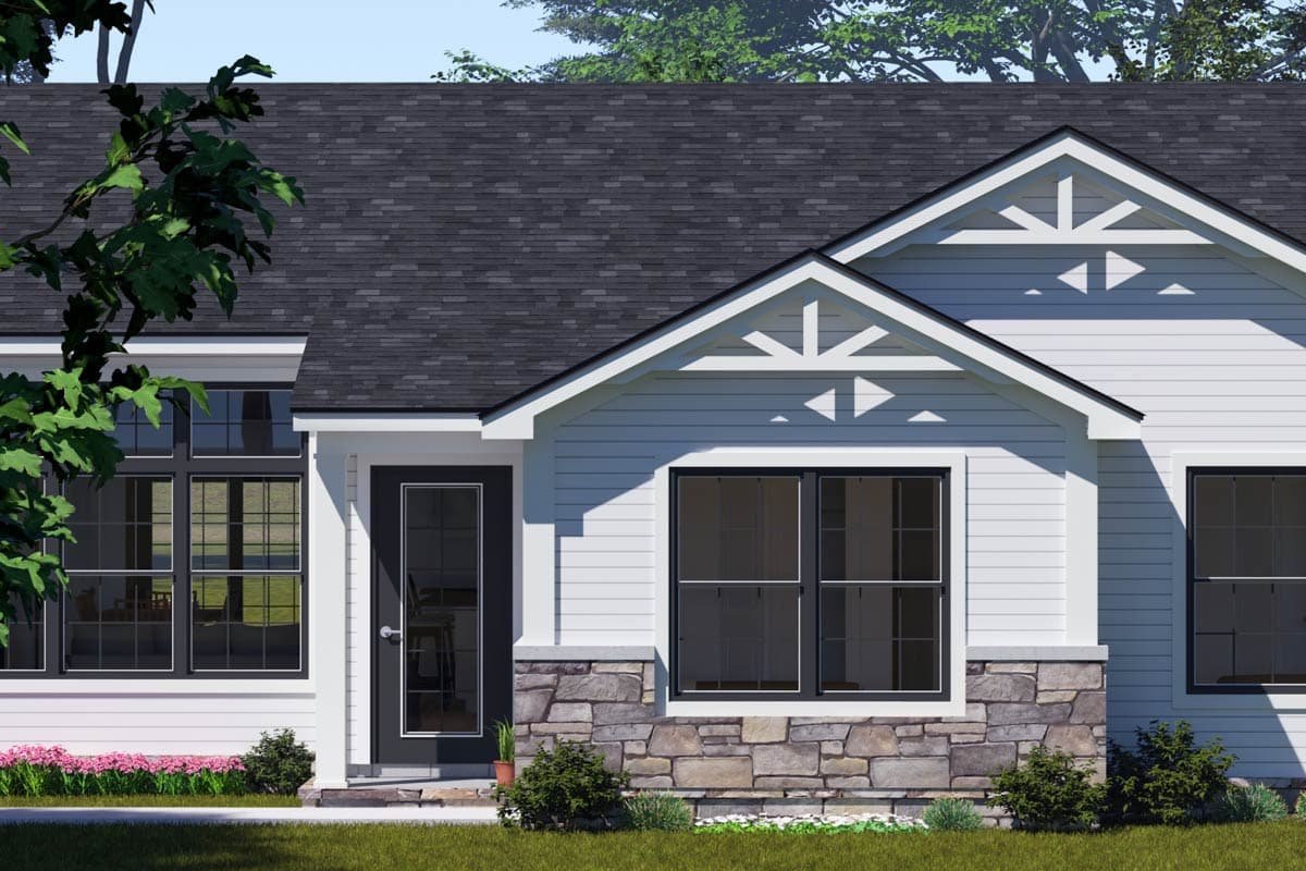 House plan exterior: White siding, stone base, gabled roof, decorative gable brackets, and dark-framed windows.