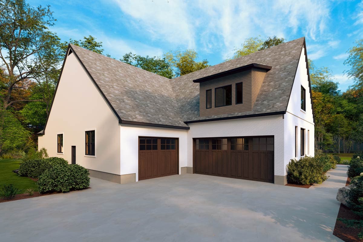 House plan exterior with a gambrel roof, white brick facade, and a three-car garage with wooden doors.