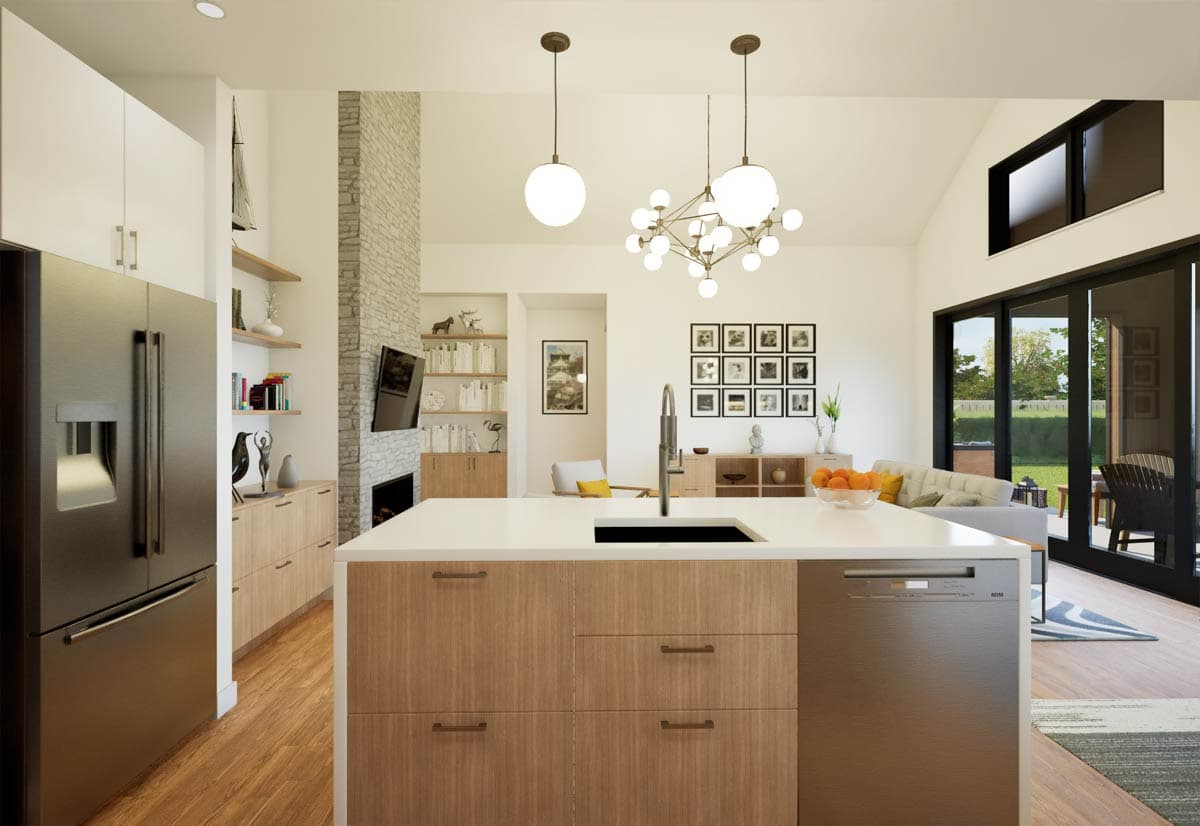 Open-concept kitchen and living area with a large island, stone fireplace, vaulted ceiling, and sliding glass doors to the exterior.