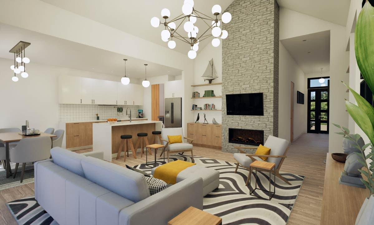 Open-concept living space with kitchen island, dining area, seating area, and stone fireplace.