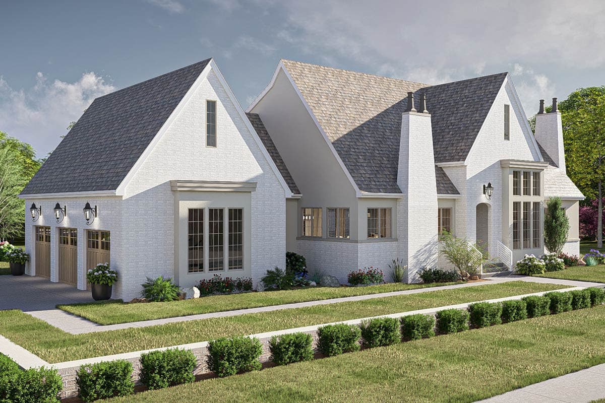 House plan exterior: Modern Tudor style with white brick, prominent gables, arched entryway, and a three-car garage.