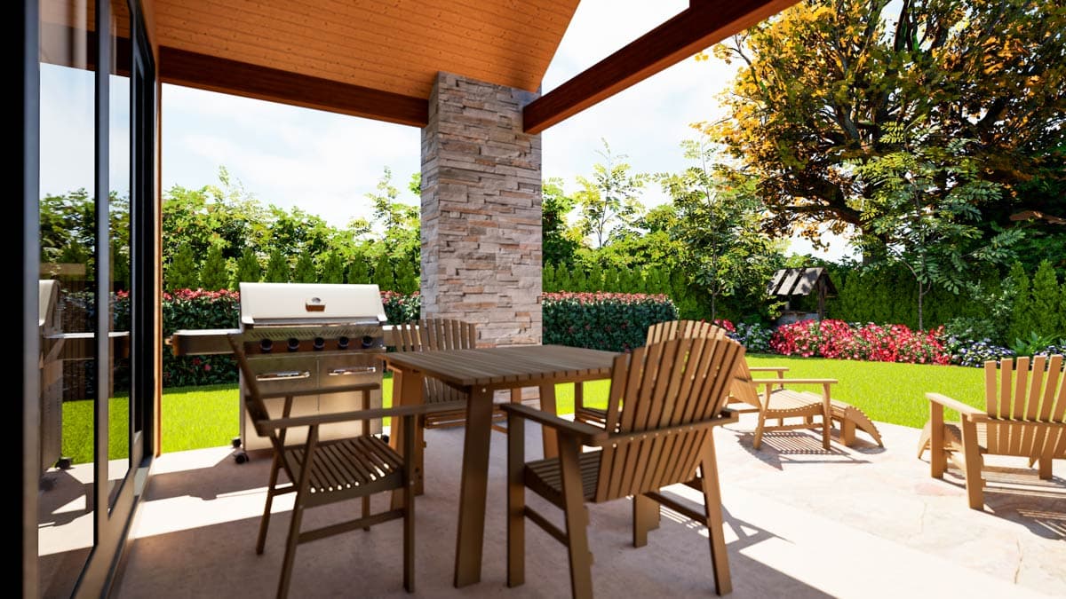 Covered patio with stone column, outdoor grill, and seating opens to a landscaped backyard with a wishing well.