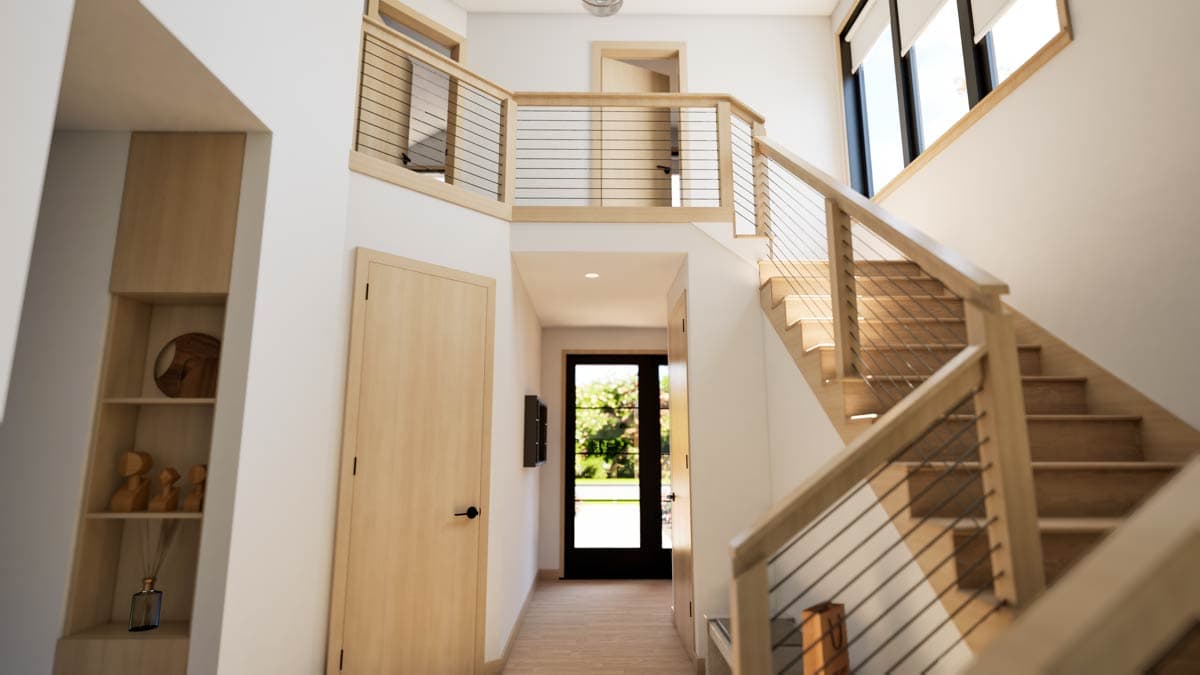 Interior view of a modern house plan with a floating staircase featuring wood treads and cable railings, wood-paneled doors, and built-in shelving.