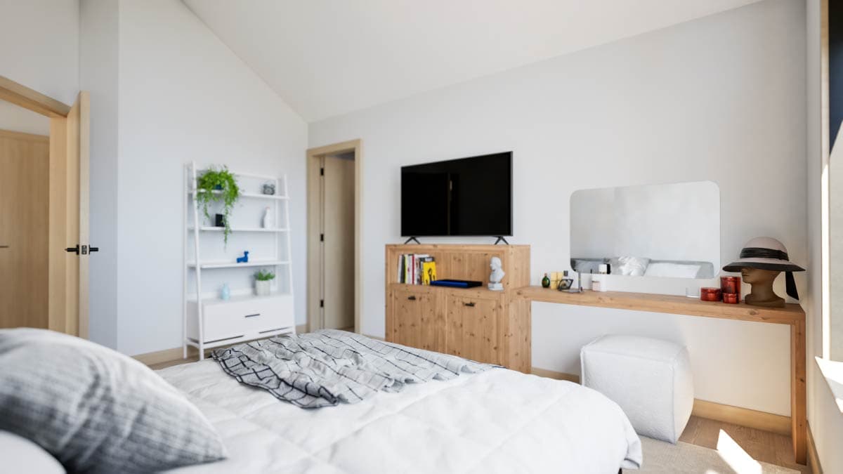 Bedroom interior with pitched ceiling, wooden media console, shelving unit, and vanity.
