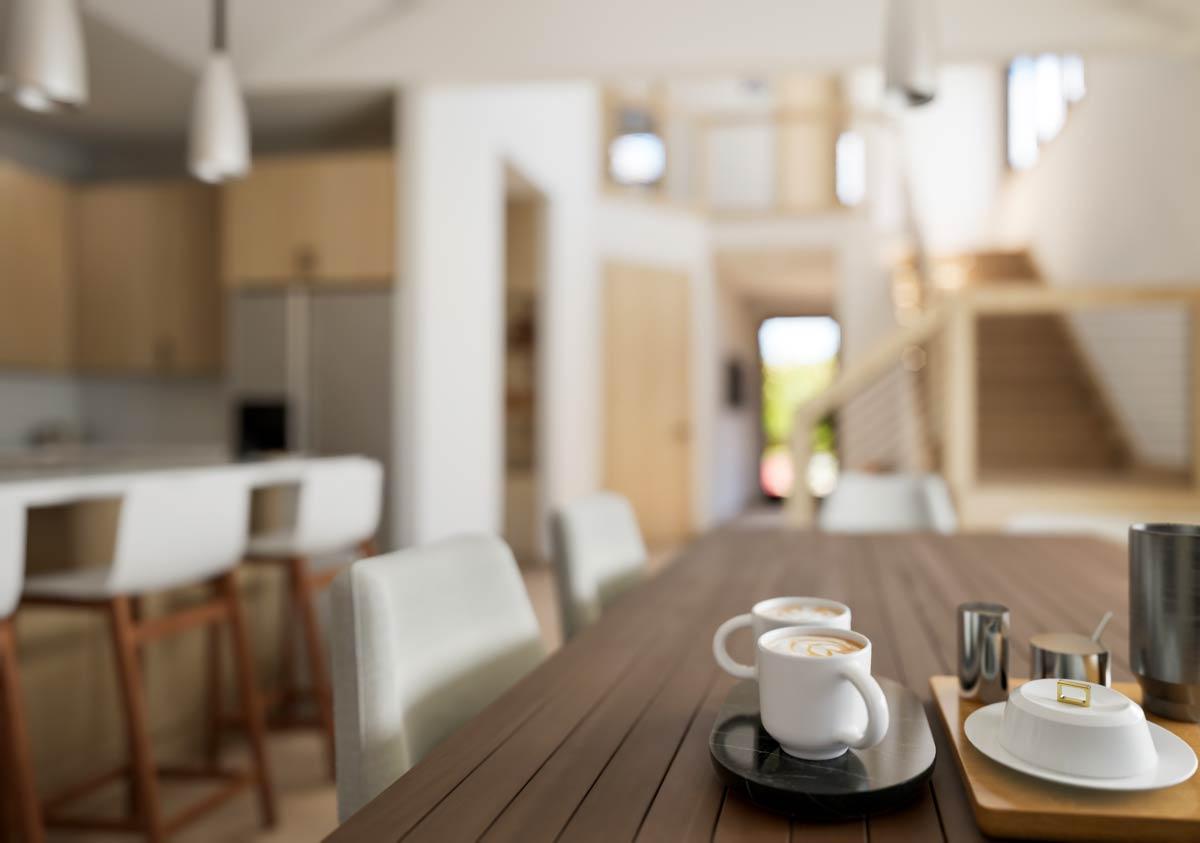 Interior rendering of a dining area and kitchen with island seating, a staircase, and modern pendant lights.