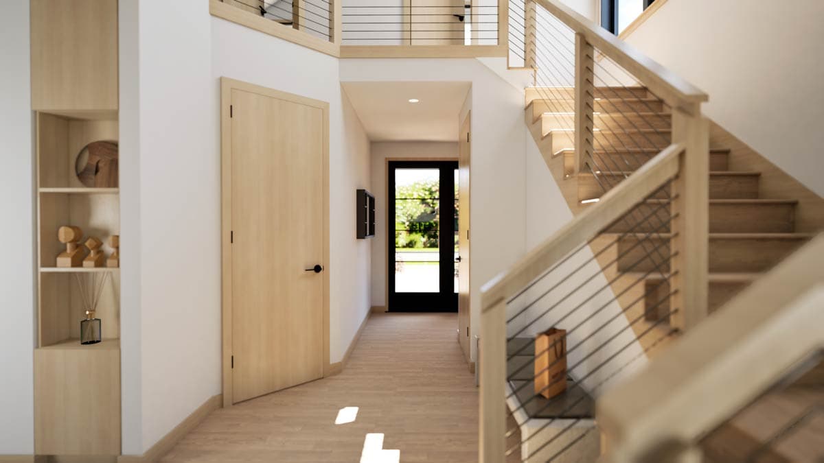 Interior view of entryway with light wood finishes, open staircase with cable railing, and a glass-paneled door.