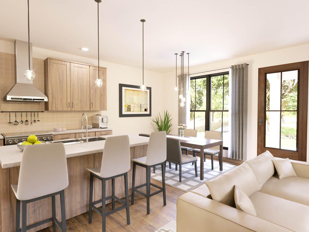 Open-concept living space featuring a kitchen island with seating, dining area, and sofa.