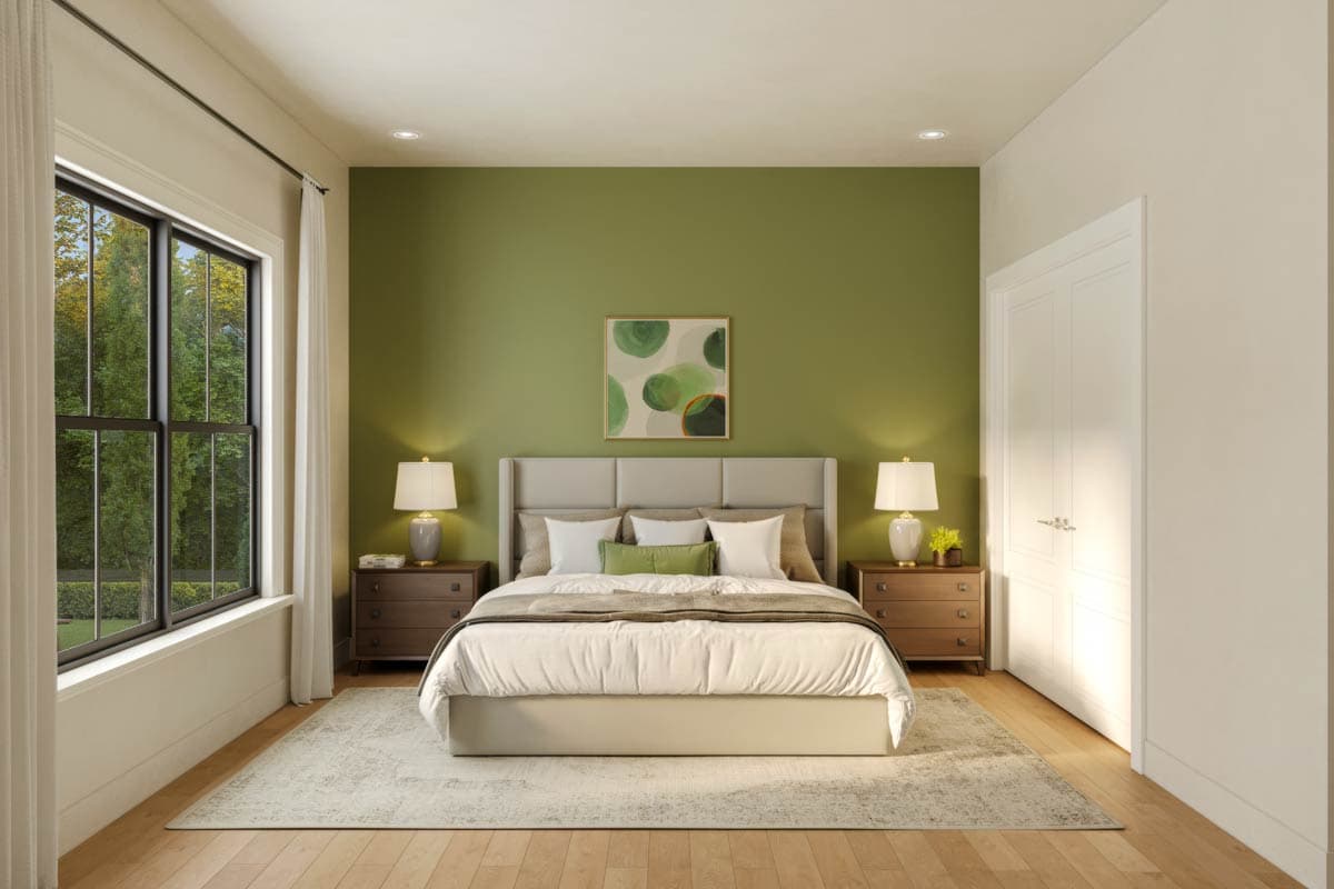 Bedroom interior with a large window, upholstered headboard, nightstands with lamps, and a green accent wall.