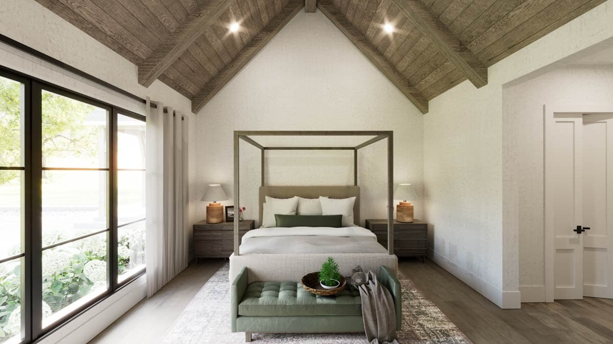 Spacious bedroom with a four-poster bed, wood ceiling and large windows overlooking the outside.