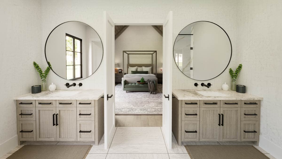 Elegant bathroom design with dual sinks, round mirrors, and an open doorway leading to a bedroom with a canopy bed.