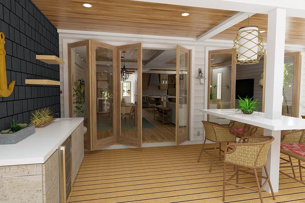 Coastal home rendering: covered deck with outdoor kitchen, bi-fold doors opening to dining area and living room with fireplace.