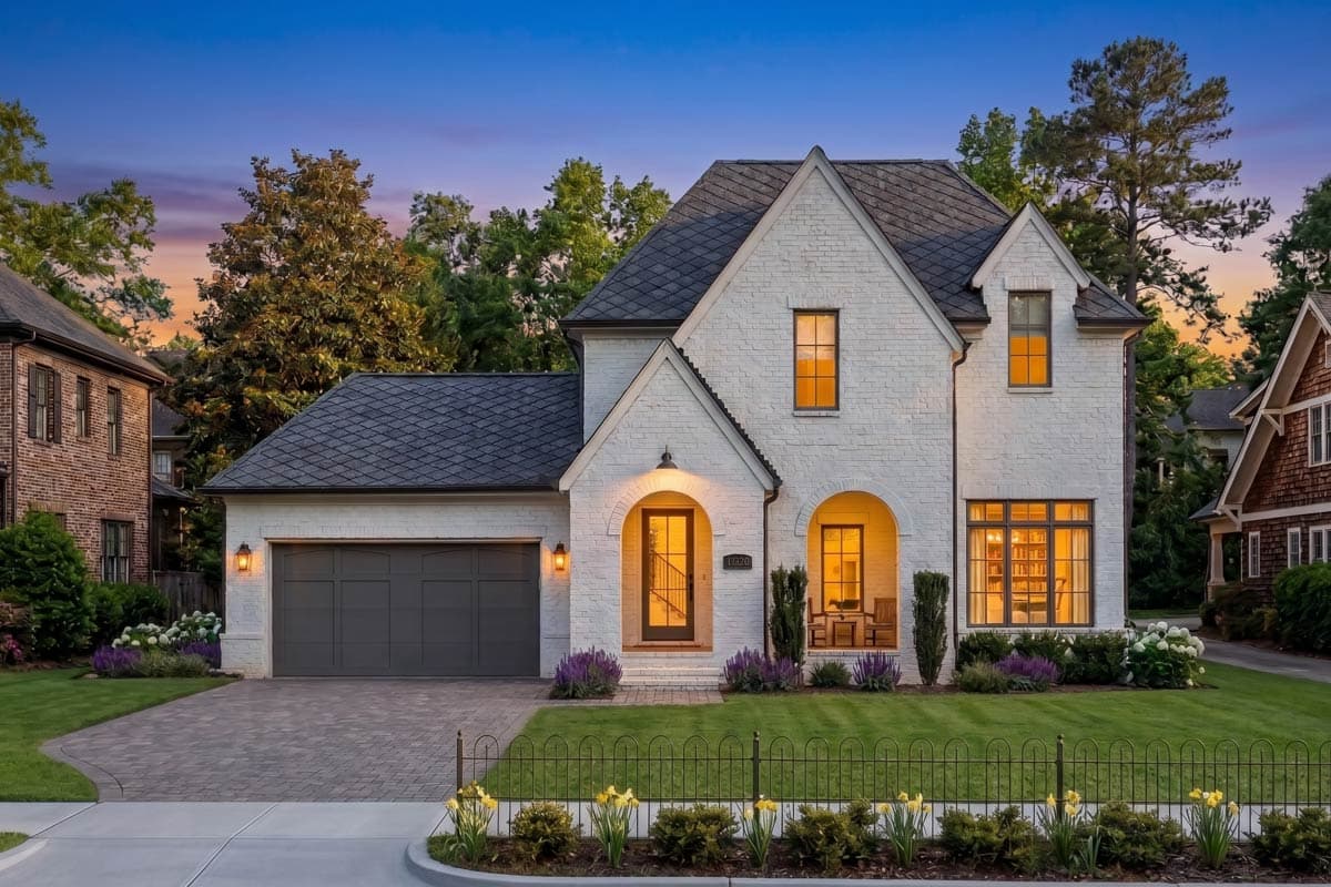 Modern Farmhouse style house plan exterior with white brick, gabled roof, arched entry, and attached garage.