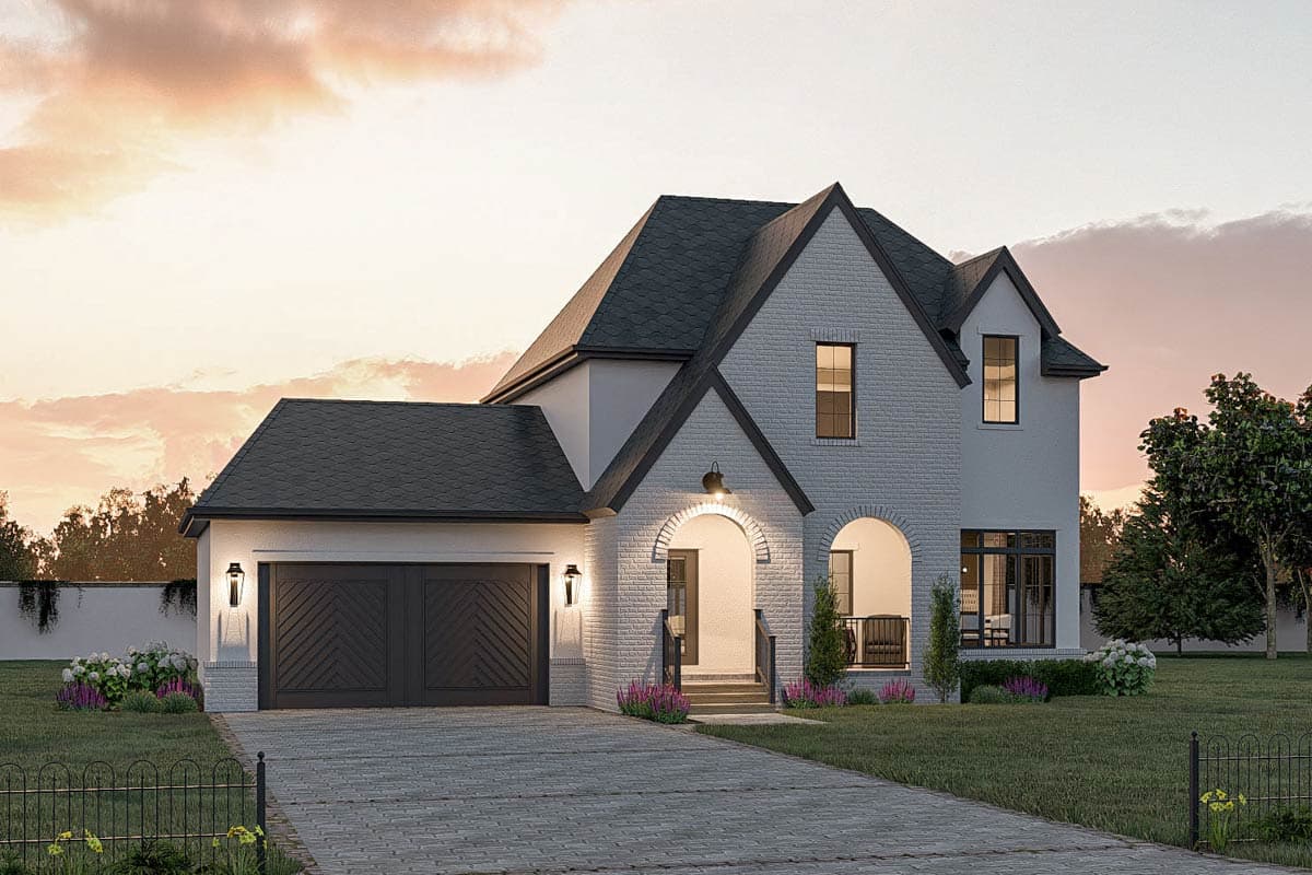House plan exterior of a two-story home with a white brick facade, arched entryways, and a two-car garage.