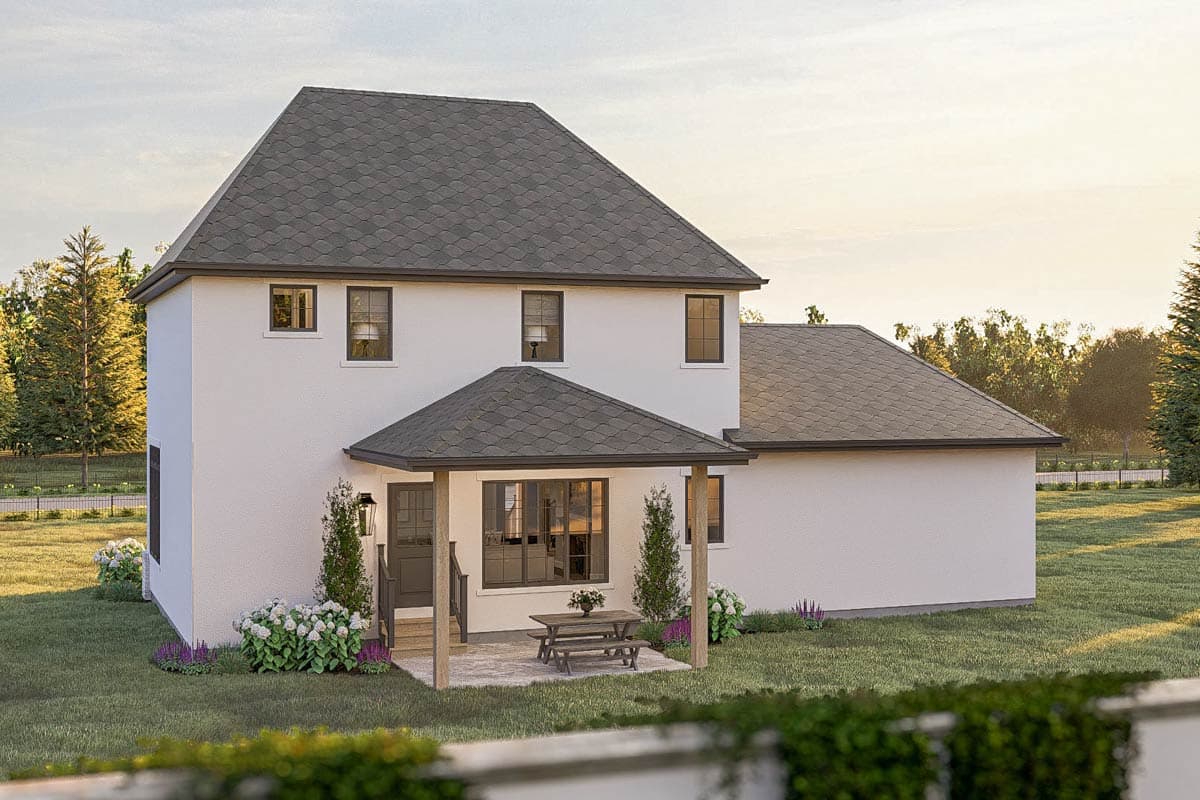 House plan exterior: Two-story home with white stucco, hip roof, covered porch with picnic table, and numerous windows.