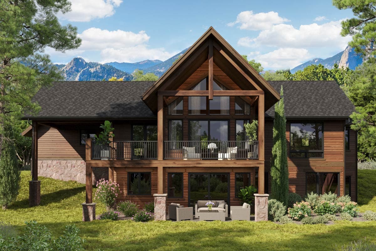House plan exterior: Modern lodge style, two stories, large gable with expansive windows, wraparound balcony, and stone base.
