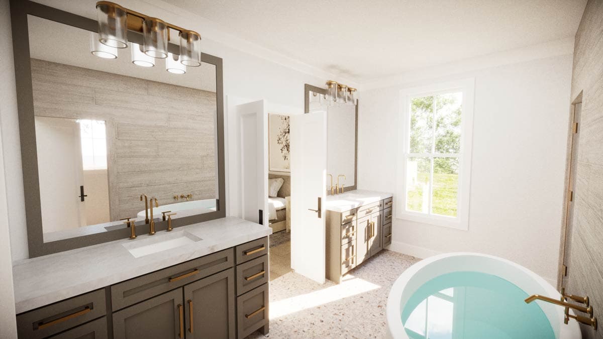 Luxurious bathroom with dual vanity, large mirror, and soaking tub. Features gold fixtures and natural light from a window.
