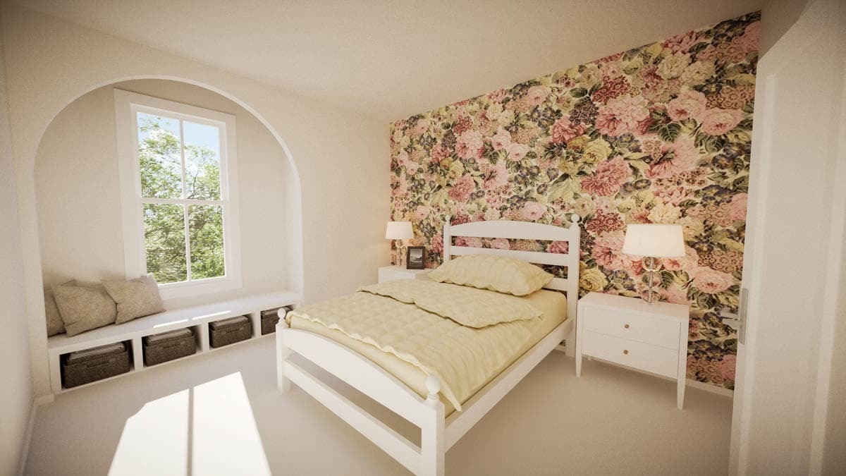 Bedroom with floral wallpaper, a white bed, and a window seat. Sunlight streams in. 
