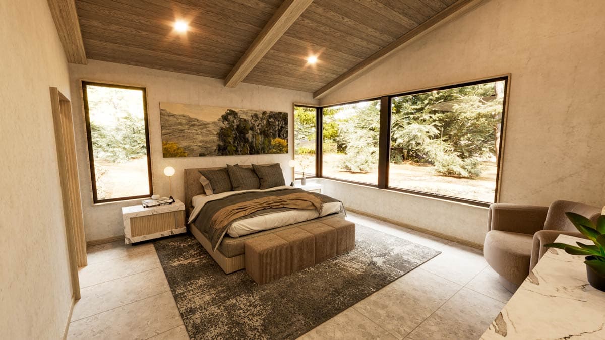 Modern bedroom with large windows overlooking a forest. Includes bed, bench, rug, armchair, and artwork.