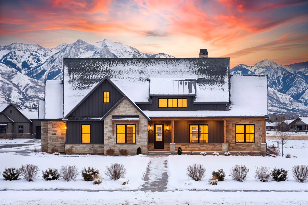 Modern Farmhouse style house plan exterior with stone and vertical siding, covered porch, dormer, and prominent gable.