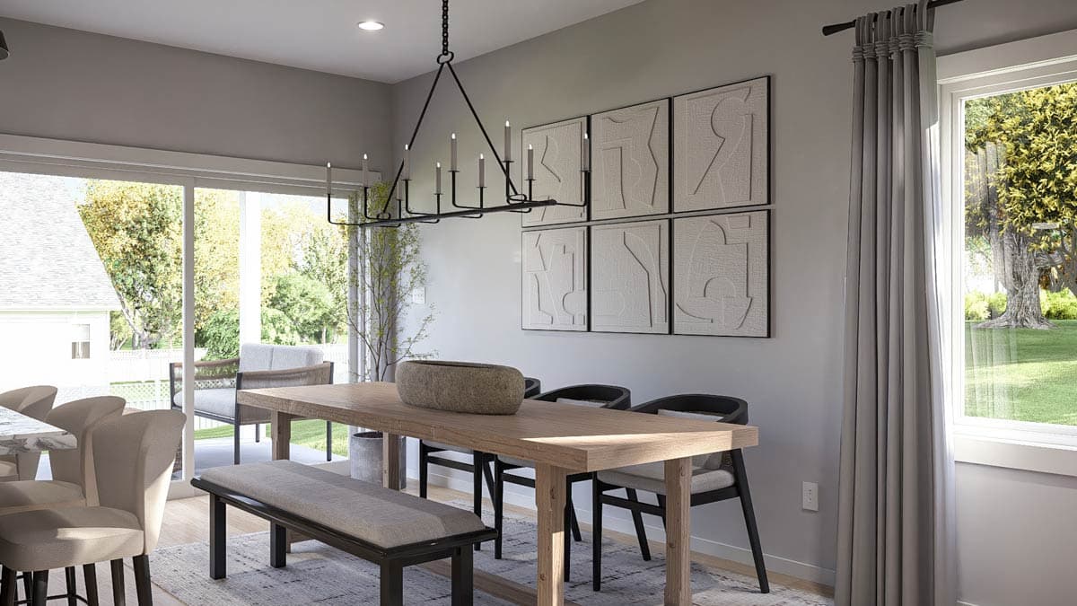 Dining room with a wood table, bench, chairs, contemporary chandelier, and patio doors.