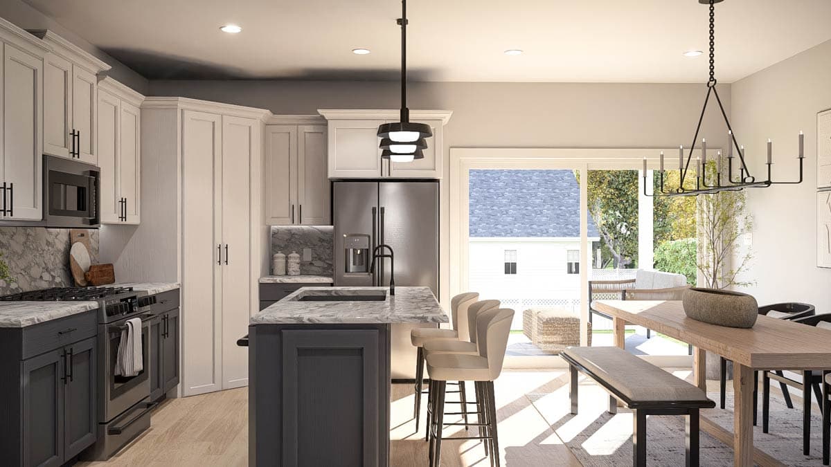 Modern kitchen with island, stainless steel appliances, marble countertops, and adjacent dining area with sliding glass doors.