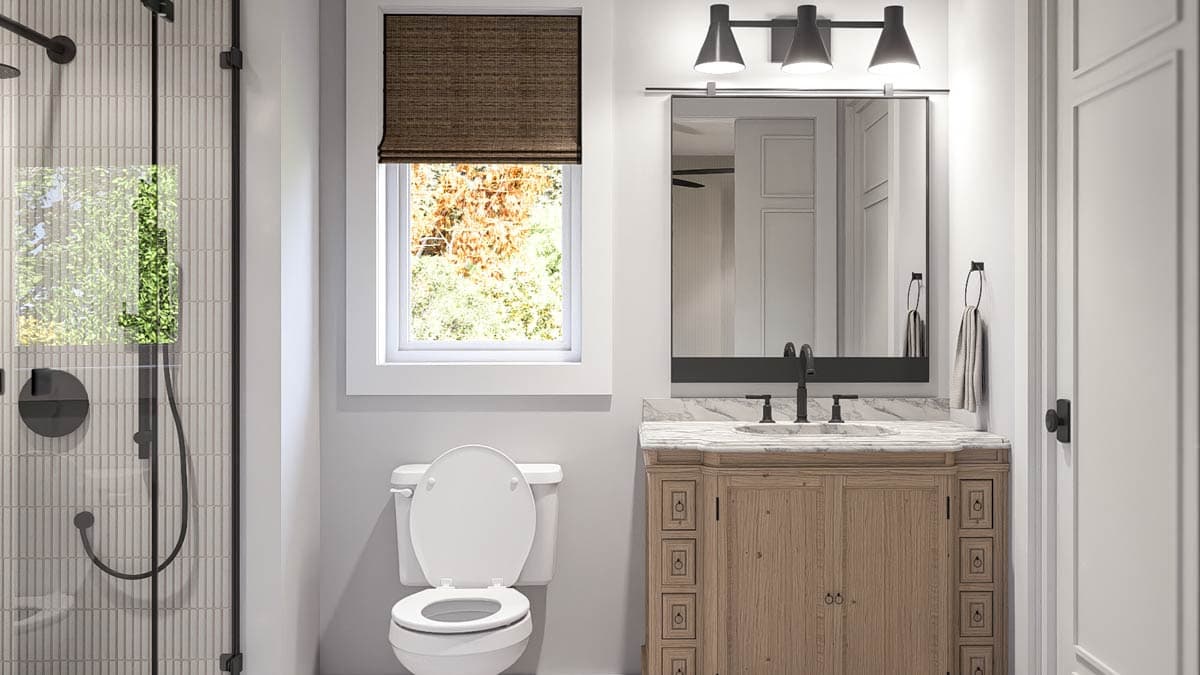 Bathroom with glass-enclosed shower, wooden vanity, marble countertop, and toilet.