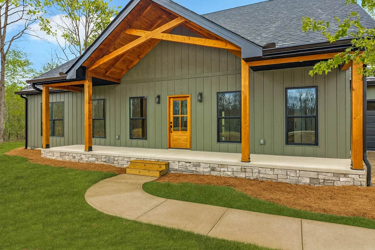 House plan exterior with covered porch, visible wood beam accents, board and batten siding, and stone foundation.
