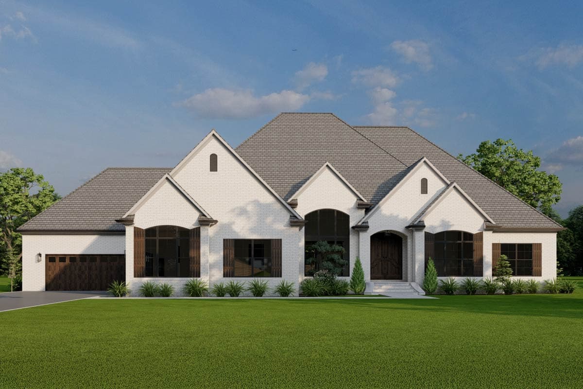 House plan exterior. One-story, brick facade, featuring a gabled roof, arched windows, and a side-entry garage.