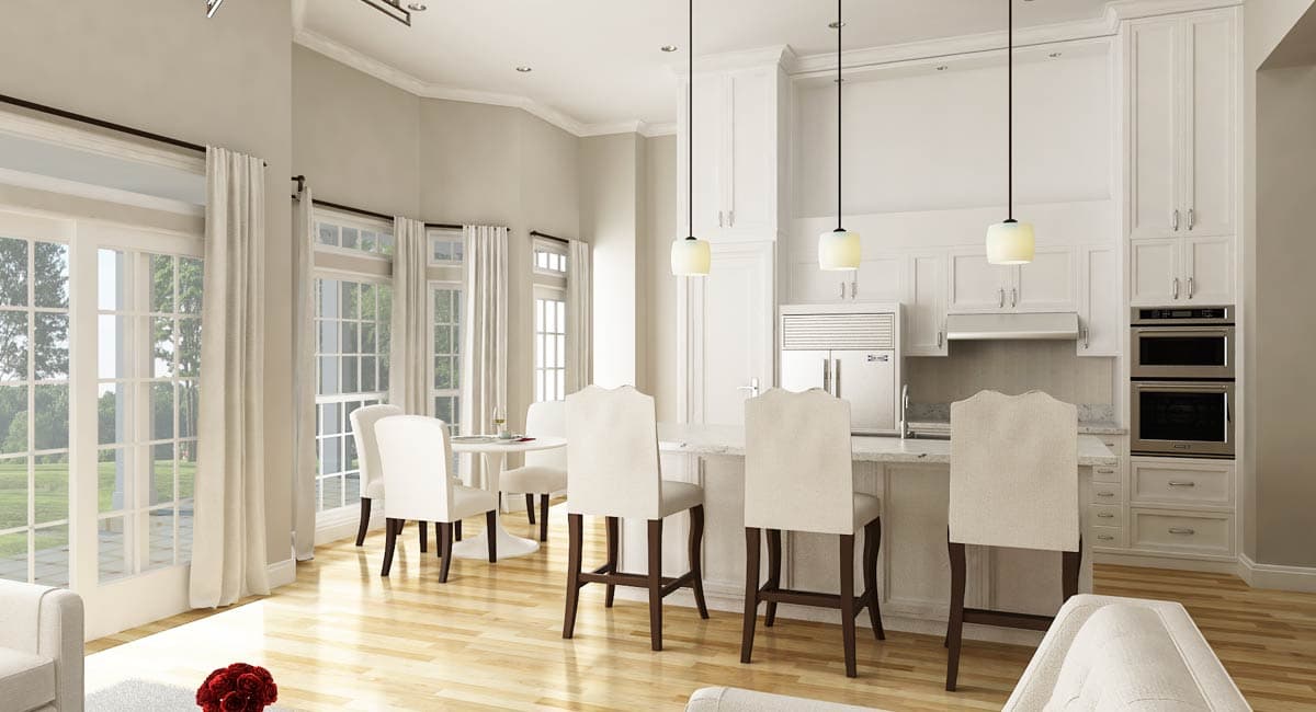 Open-concept kitchen with island, bar stools, integrated refrigerator, and double ovens. Dining area with chairs and table.