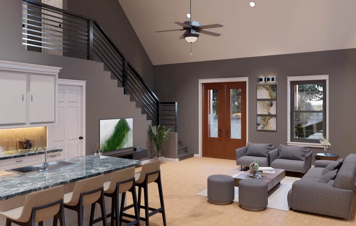 Open-concept living area with vaulted ceiling, kitchen island, fireplace, and glass double doors.