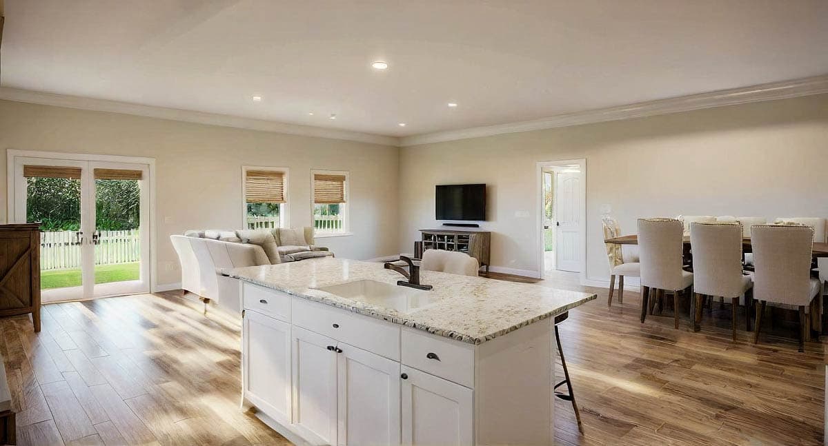 Open concept living area with kitchen island, dining table, and living room. French doors lead to backyard.