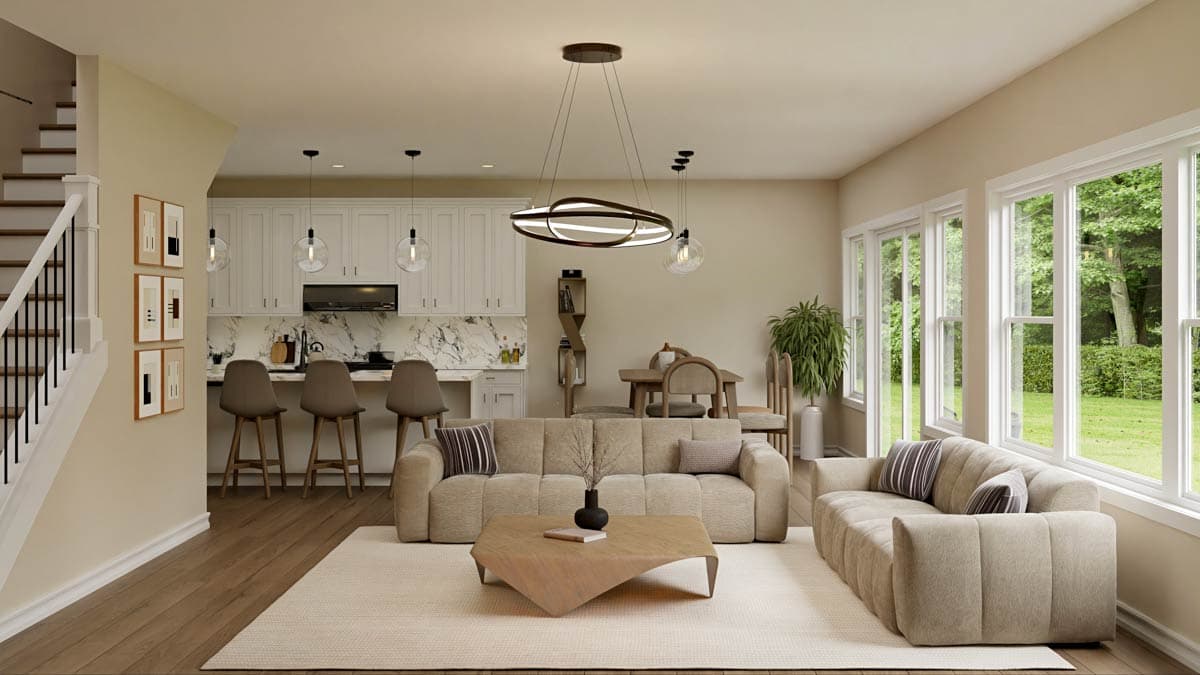 A modern, open-concept living space with a kitchen, living area, and dining space. Large windows overlook a lush green backyard.