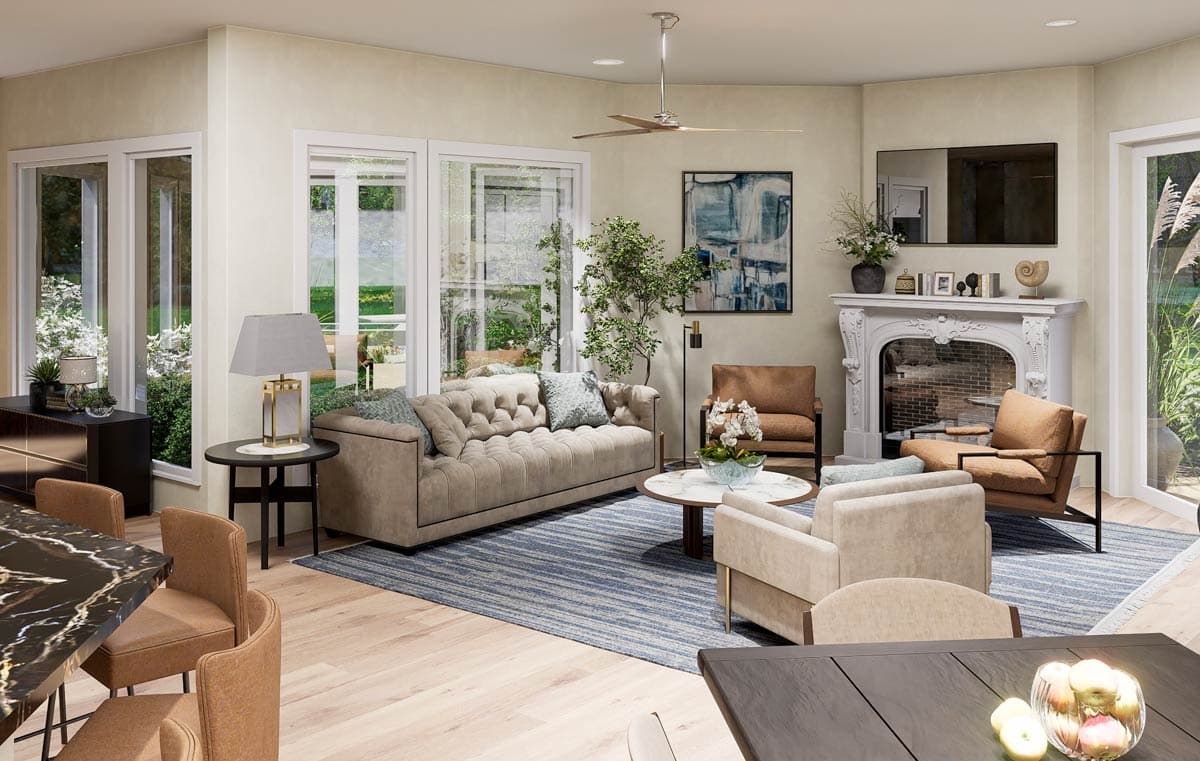 Living room with tufted sofa, fireplace, chairs, coffee table, and large windows.