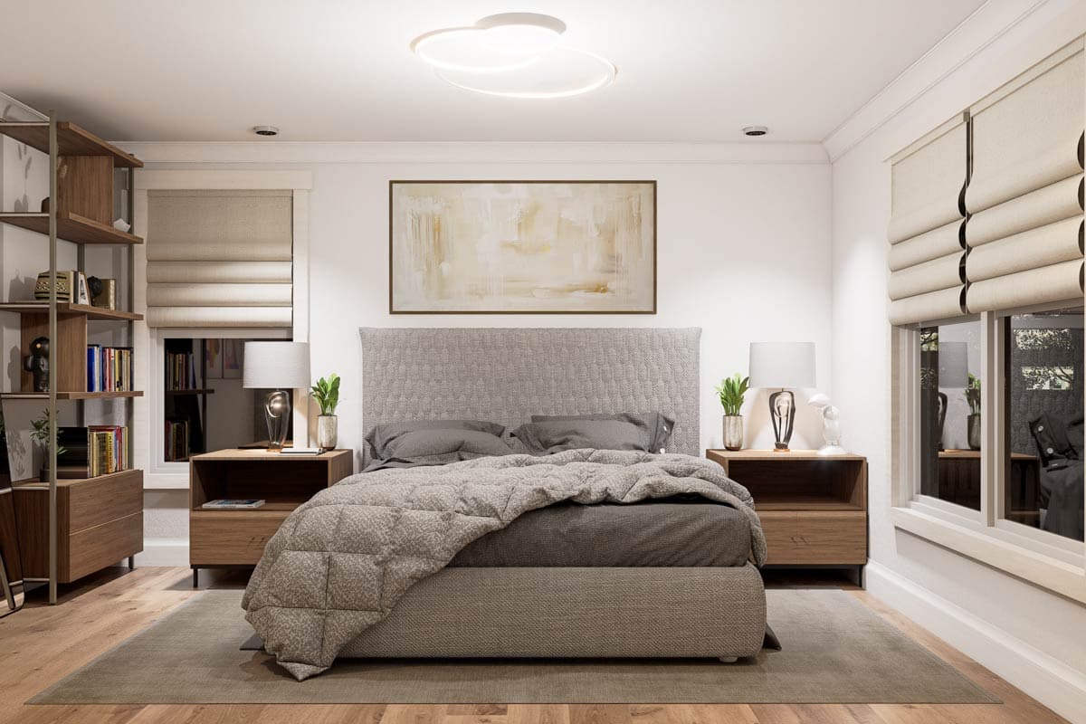 Bedroom interior featuring a bed with a gray headboard, lamps on nightstands, and abstract art above.