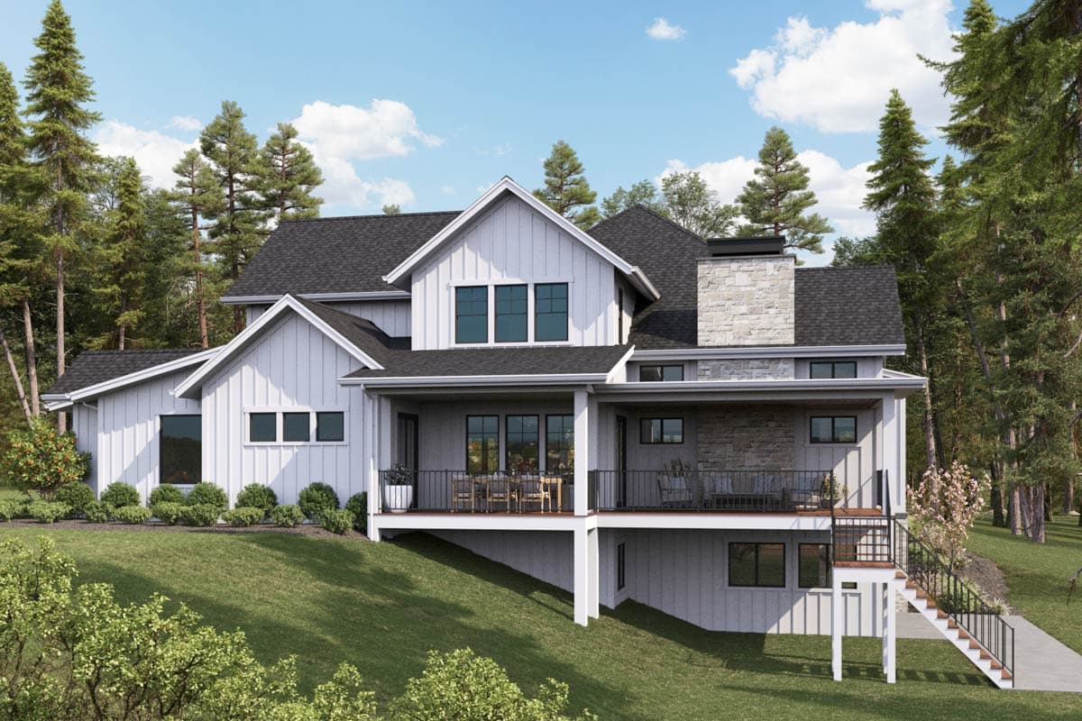 Modern Farmhouse house plan exterior with white board and batten siding, multiple gables, two covered decks, and stone chimney.