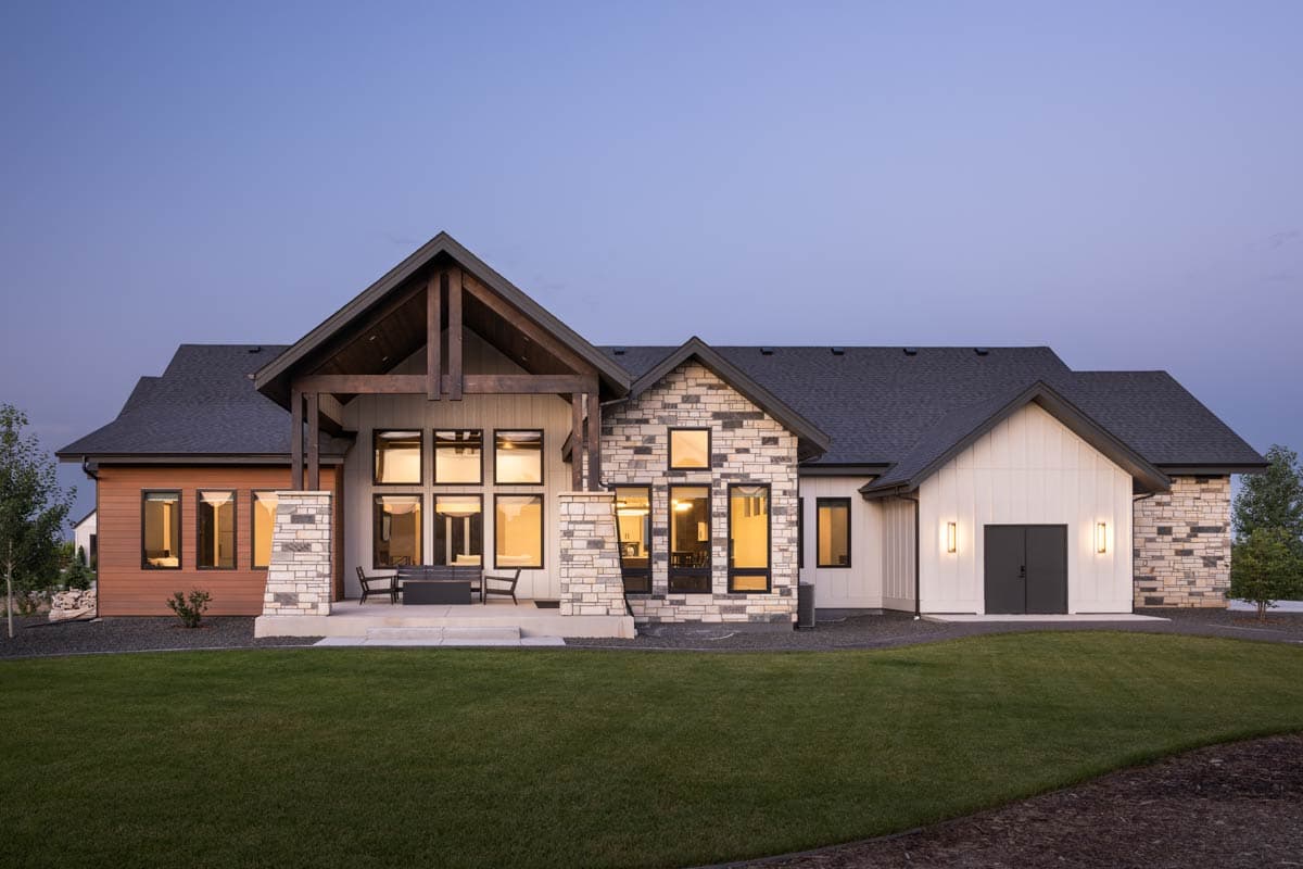Modern house plan exterior with stone accents, large windows, exposed timber beams, and a covered patio.